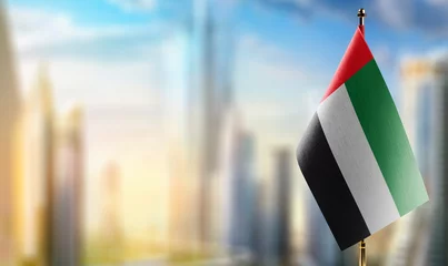 Wall murals Abu Dhabi Small flags of the Arab Emirates on an abstract blurry background