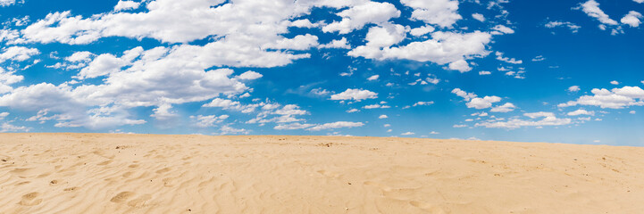 sand dunes and cloudy blue sky