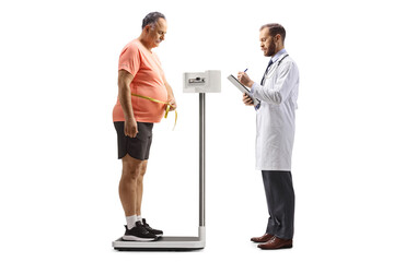 Doctor checking weight and mature man standing on a weight scale