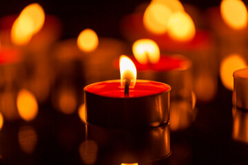 candle,Burning candles on a dark memorial day surface,Many burning candles with a shallow depth of field.