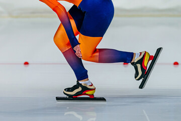 Fototapeta premium close-up female skaters in bright skin suit run in speed skating competition, winter sports games