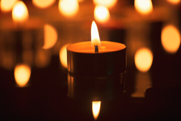 candle,Burning candles on a dark memorial day surface,Many burning candles with a shallow depth of field.