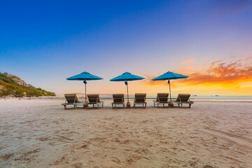 Beaches and sun tables in Thailand,Row of empty sun loungers and orange parasols on the tropical...