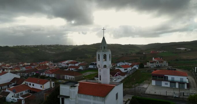 Aerial view of a small Beautiful Church in Portugal. Amazing drone view of Igreja Paroquial de Casal Novo during sunset.