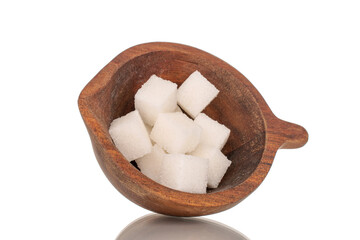 Several cubes of white sugar with wooden cup, macro, isolated on white background.