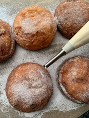 Naklejka premium Gluten and sugar-free donuts, homemade, with quark filling, erythritol powdered sugar,Piping bag with piping nozzle