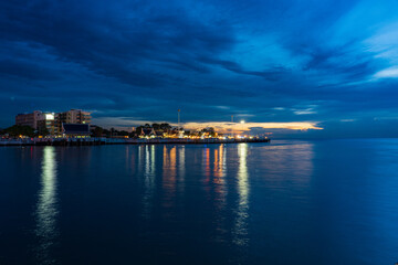 Pattaya, Thailand - September 5 2020 : Market walking area with many street shops and hotels in twilight view from the middle of the sea.