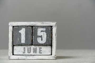 Calendar for June 15, made wooden cubes, on gray background.With an empty space for your text.