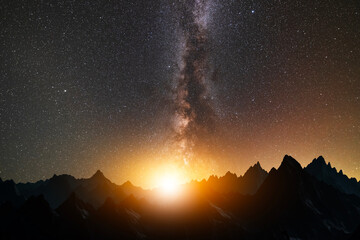 Fantasy night landscape. Beautiful mountains silhouette in the starry night with milky way galaxy.