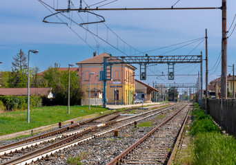 Fototapeta na wymiar Sommariva del Bosco, Cuneo, Italy - 05 April 2023: Railway station overlooking the tracks of the railway line between Alba and Turin