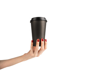 Woman's hand holding black paper cup of coffee for take away. Drink, start of the day, morning concept.