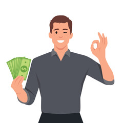 Happy young man holding cash or money or banknotes and gesture okay sign. Financial money concept.