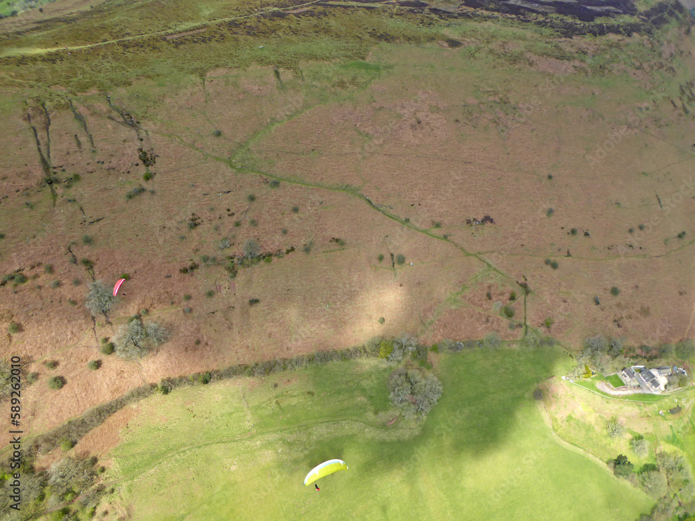 Poster paragliding above the ridge at pandy, wales