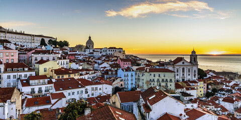 Fototapeta na wymiar Alfama old town district at sunrise viewed from Miradouro das Portas do Sol observation point in Lisbon, Portugal