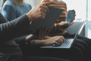 Beautiful woman sitting on a outdoors and using at laptop. Woman and friend having fun with new technology and shopping online at outdoor place.