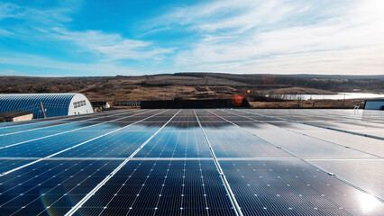 Multiple solar panels on the roof of a manufacturing building