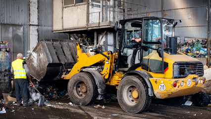 Fototapeta na wymiar An excavator working at waste sorting plant