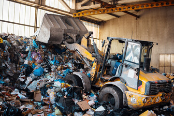 An excavator working at waste sorting plant