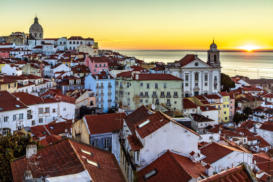 Alfama old town district at sunrise viewed from Miradouro das Portas do Sol observation point in Lisbon, Portugal