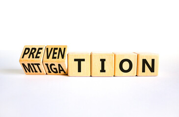 Prevention or mitigation symbol. Businessman turns cubes and changes the concept word Mitigation to Prevention. Beautiful white background. Business prevention or mitigation concept. Copy space.