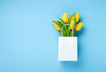 Holiday Yellow Tulip Flowers Bouquet for Mothers Day on Blue Background.