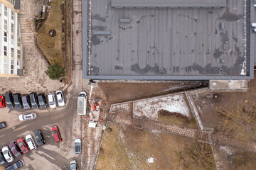 Drone photography of people putting sign on a building during cloudy spring morning.