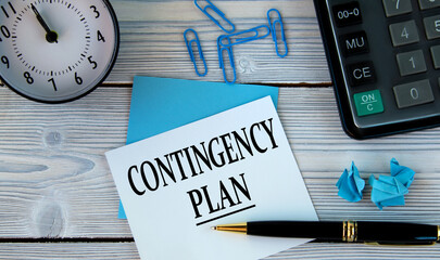 CONTINCENCY PLAN - words on a white sheet on the background of a calculator, alarm clock and pen