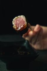 woman hand holding a sushi