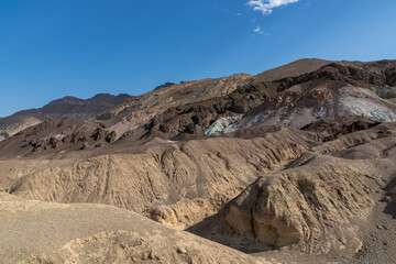 Fototapeta na wymiar Scenic view of colorful geology of multi hued Amargosa Chaos rock formations in Death Valley National Park, Furnace Creek, California, USA. Barren desert landscape of Artist Palette in Black mountains