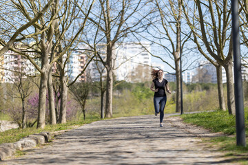 Adult sportive woman jogging in the park