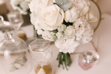 The bride's bouquet and the beautiful details of the bride's morning