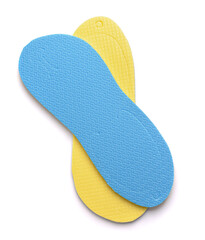 Folded blue and yellow disposable foam flip flops