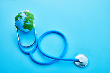 World Health Day. Global Health Awareness Concept. Globe and Stethoscope on blue background.