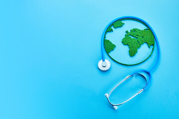 World Health Day. Global Health Awareness Concept. Globe and Stethoscope on blue background.