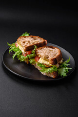 Delicious caprese sandwich with grilled toast, mozzarella, lettuce and tomatoes