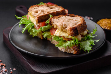 Delicious caprese sandwich with grilled toast, mozzarella, lettuce and tomatoes