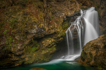 Fototapeta na wymiar Sum waterfall on Radovna river in spring color fresh Slovenia