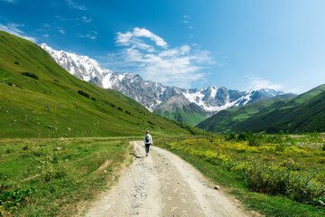 Fototapeta na wymiar Young active girls hiking in Greater Caucasus mountains, Svaneti region, Mestia district, Svaneti, Georgia