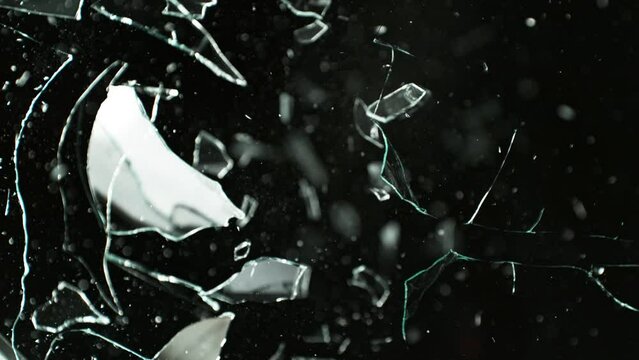Super Slow Motion Shot of Real Bullet Glass Break Isolated on Black Background at 1000fps.