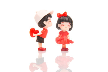 miniature people. figures for the game. romantic couple of young people. A boy lovingly gives his heart to a cute girl