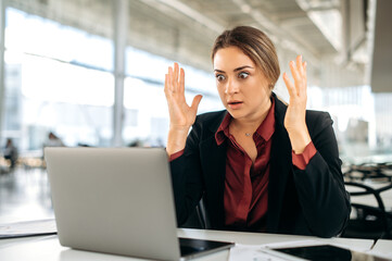 Shocked stunned caucasian woman, manager, office employee, sit in the office, looks in surprising...