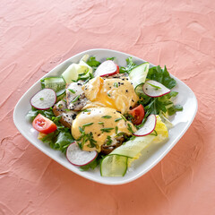 Cheese toast and fresh vegetable salad. Dish for breakfast, lunch. Dish on white plate. Salmon background. View from above. Copy space. 