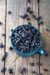 Juicy ripe honeysuckle in a blue cup