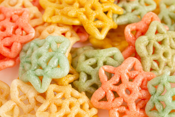 Cooked Star Shaped Fryums on a White Background