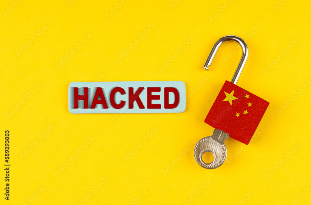 Aufkleber on the yellow surface is an open lock with a key and a sticker with the inscription - hacked