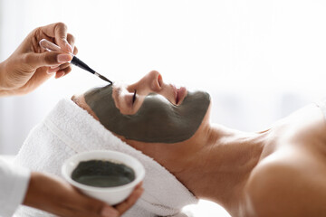 Anti Aging Skincare. Cosmetologist Applying Mask On Face Of Beautiful Middle Aged Woman