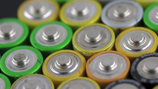 Close up of positive ends of AA batteries, of electric batteries and accumulators AAA
