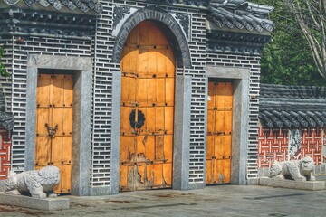 beautiful brick arch with wooden gates ancient Chinese style. with tiles on the roof