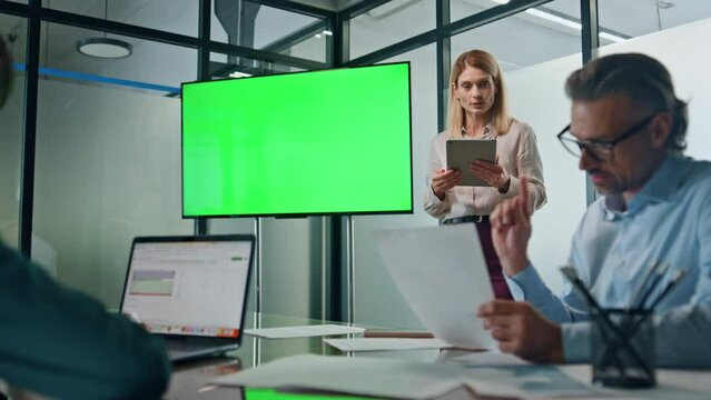 Boss lady presenting chromakey project in boardroom. Woman mentor consulting