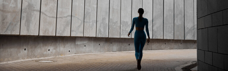 Beautiful fit young woman jogger is running outdoors